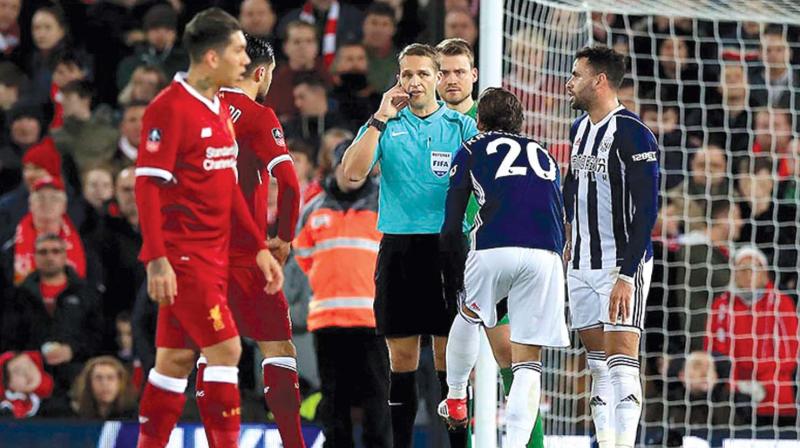 Craig Pawson disallows a West Brom goal after consulting with VAR, during a match with Liverpool. (Photo: PTI)