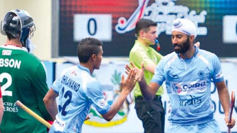Shilanand Lakra (second from left) celebrates his first international goal with teammate Talwinder Singh against England in their Azlan Shah Cup in Ipoh, Malaysia, on Sunday. The match ended 1-1.