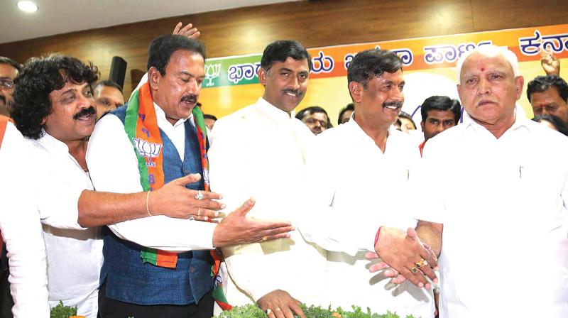 BJP state president B.S. Yeddyurappa welcomes retired police officer BNS Reddy and others to the party on Wednesday