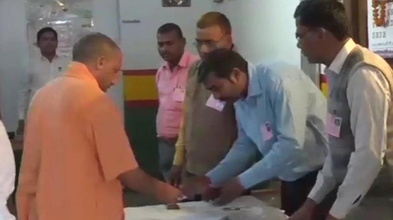 Uttar Pradesh Chief Minister Yogi Adityanath casts his vote for Gorakhpur bypolls  at a polling station, says For development and good governance, BJP is necessary. (Photo: ANI/Twitter)