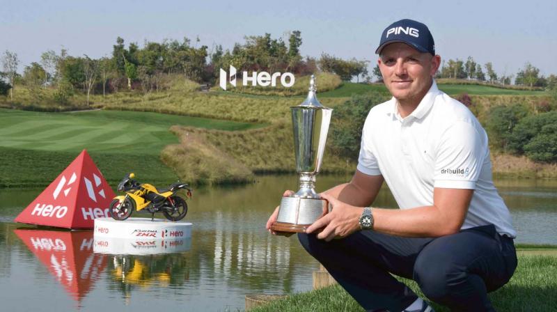 Englands Matt Wallace poses with the Indian Open winners trophy in Gurgaon on Sunday.