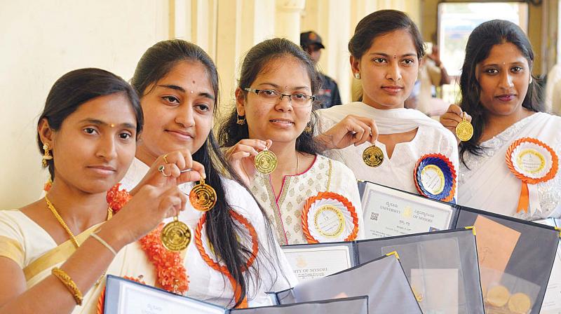 Graduating students strike a pose with their medals, in Mysuru on Monday. (Photo:KPN)