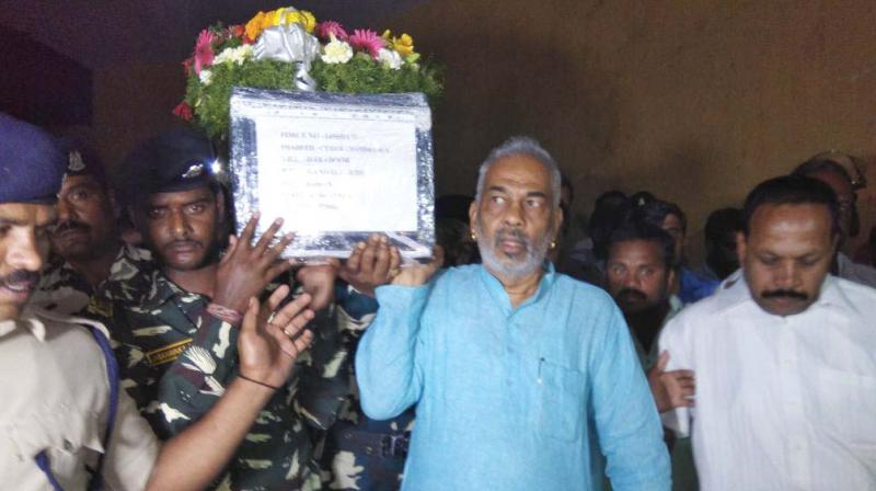 Hassan district in charge and Minister for Animal Husbandry A Manju carries mortal remains of soldier Chandra in Hassan on Wednesday