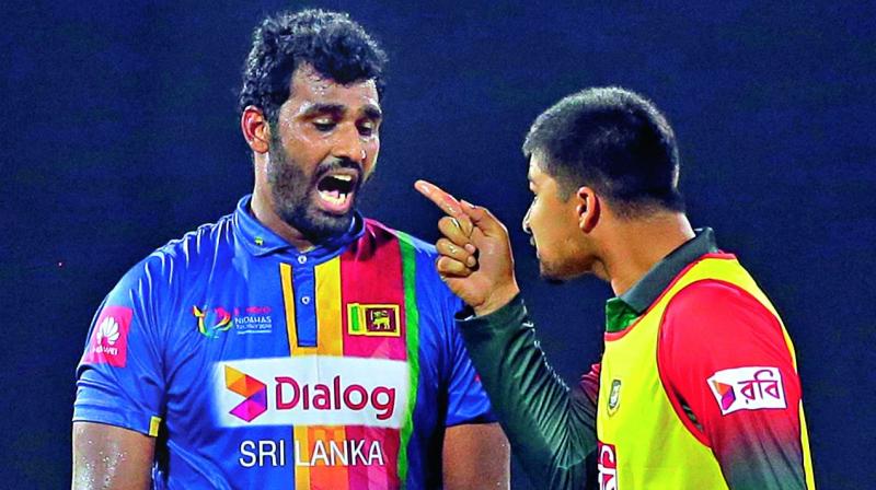 Bangladesh reserve Nurul Hasan points a finger at Sri Lanka captain Thisara Perera.  (Photo:AP)