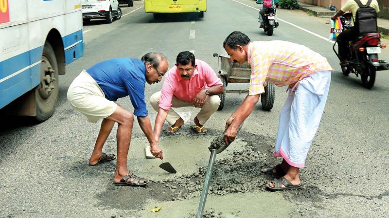 Councillors fill dangerous potholes.