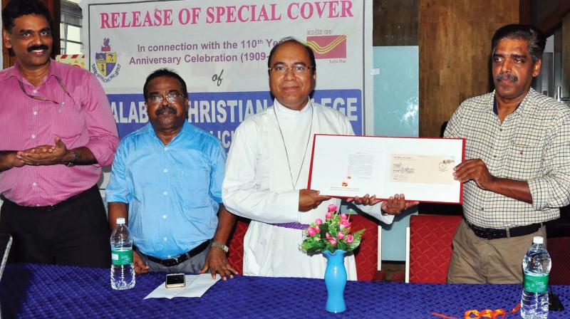 Rt.Rev. Dr Royce Manoj Victor, Bishop, CSI Malabar diocese, receives the special cover from K.Sukumaran, senior superintendent of posts, in connection with the 110th year anniversary  celebration of Malabar Christian college at Head Post Office, Kozhikode on Thursday.  (Photo:DC)