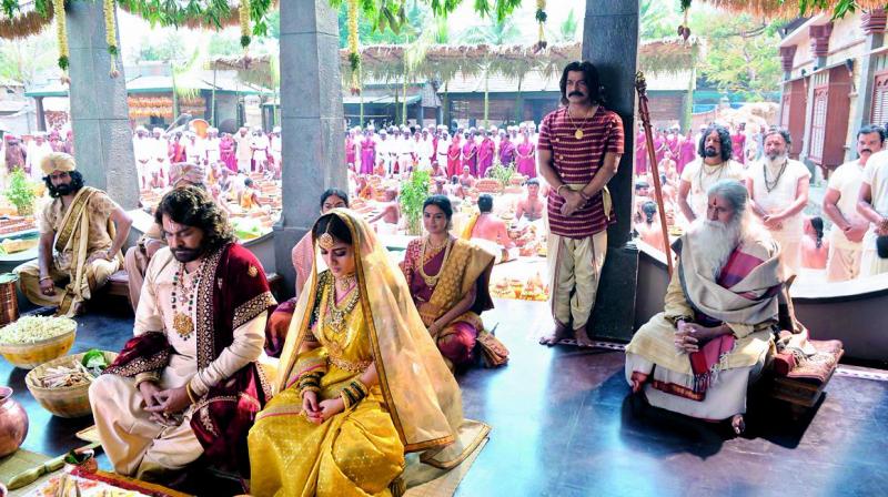 On the sets of sye raa: Chiranjeevi and Nayanathara are seen performing a ritual while Amitabh Bachchan is seen in the background.