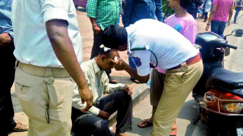 Inspector Nagamallu attending to the victims wounds.