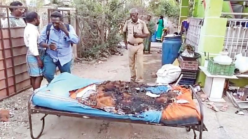 A cot destroyed by a petrol bombs hurled into the house of a  trader, in Guduvancherry on Monday. 	 (Photo:DC)