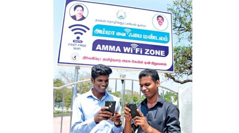 Visitors trying out newly launched Amma Wifi zone facility at Labour statue at Marina beach on Friday. Tamil Nadu Cable TV Corporation has installed the facility at Chennai, Madurai, Tiruchy, Salem and Coimbatore.  (Photo:DC)