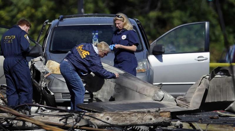 Investigators look at the remains of a small plane along Main Street in East Hartford, Connecticut. (Photo: AP)