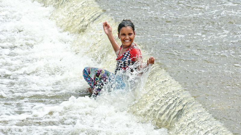 A girls plays at Kovilpathagai Lake in Avadi after water was released from the dam due to increase in the levels on Thursday.  (Photo: DC)