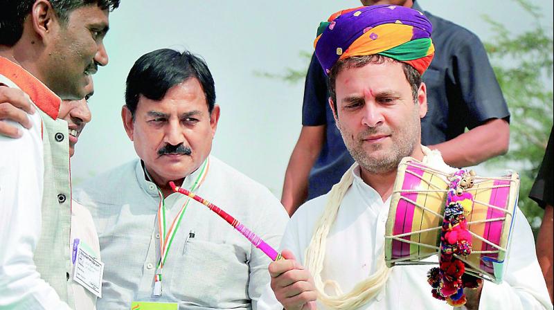 Congress vice-president Rahul Gandhi plays a musical instrument at a programme at Harij in Patan district on Monday. 	(Photo:  PTI)