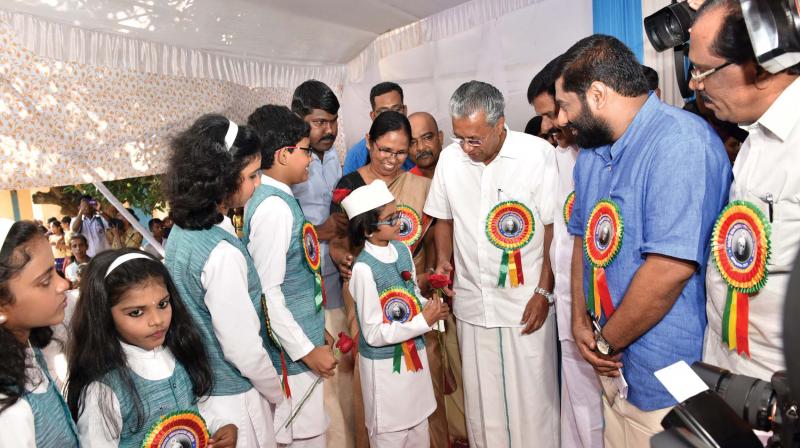 Chief Minister Pinarayi Vijayan shares a light moment with Childrens Prime Minister Abhinavamirag and President P.R. Adwaith and other representatives during Childrens Day celebrations in Thiruvananthapuram on Tuesday. (Photo: Peethambaran Payyeri)