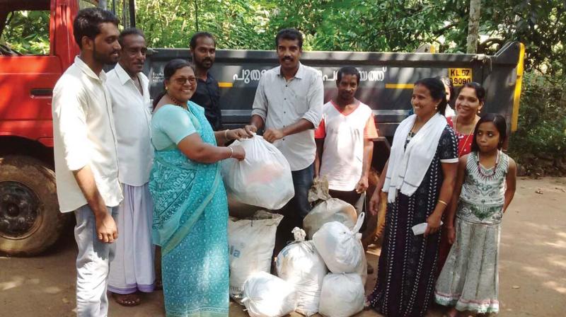 Members of My Nature Resource Management company collect waste.