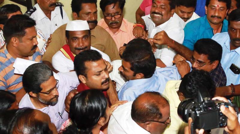 Mayor V.K. Prasanth gets blocked by BJPs V.G. Girkumar as he tries to move towards the flight of stairs close to the council hall on Saturday. (Photo: DC)