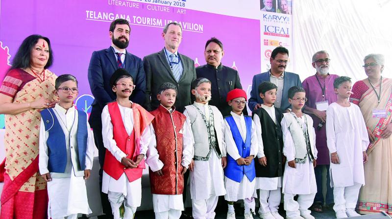 Children dressed as eight Gnyanpith awardees of Karnataka pose with deputy head mission of Spanish embassy, Eduardo Sanchez Moreno (third from left), cultural attache, Ignacio Vitorica Hamilton (second from left), chief secretary S.P Singh (centre) and artist Sonal Mansingh (left) at the Hyderabad Literature Festivalon Friday.	DC