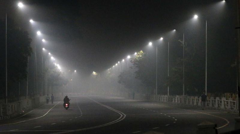 As pollution soars and temperatures dip, the city witnessed thick blanket of smog in the early hours of Friday. A scene on Kamarajar Salai at around 6.30 am on Friday.  	DC