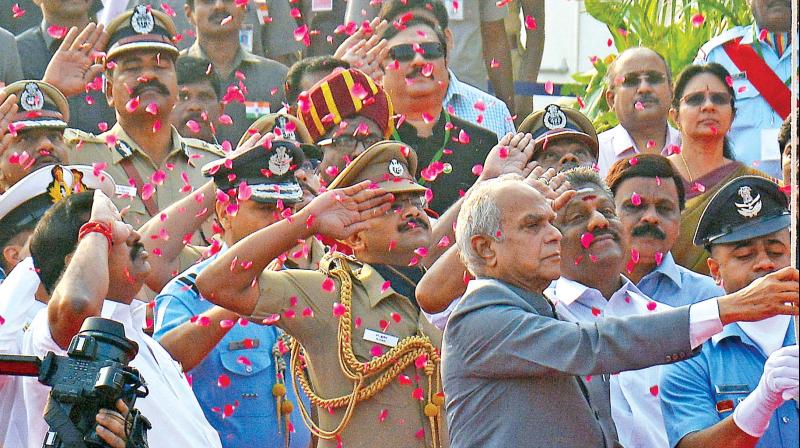 Governor Banwarilal Purohit hoists national flag near the Gandhi Statue at his maiden Republic Day celebrations in the city on Friday. 	 DC