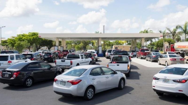 Lines of cars snaked around those gas stations that remained open in Miami, as Florida prepared for Hurricane Irma. (Photo: AFP)