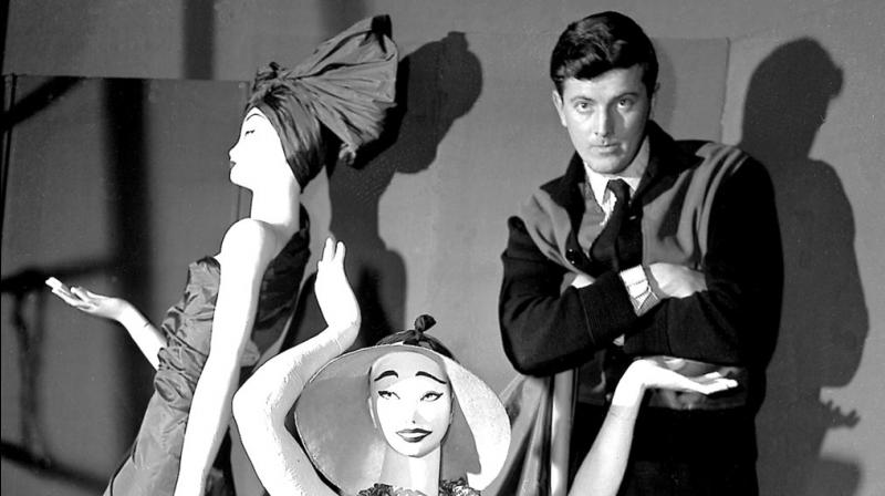 In this Feb.1 1952 file photo, French fashion designer Hubert de Givenchy poses with mannequins in his shop in Paris. French couturier Hubert de Givenchy, a pioneer of ready-to-wear who designed Audrey Hepburns little black dress in \Breakfast at Tiffanys,\ has died at the age of 91. (Photo: AP)