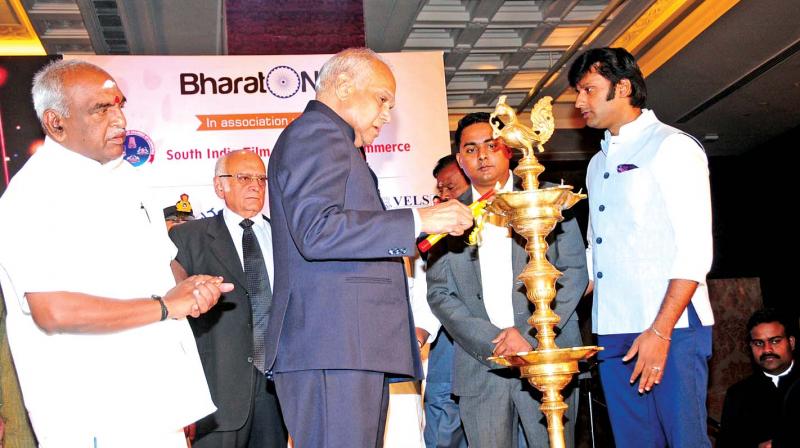 Governor Banwarilal Purohit lights the traditional lamp to inaugurate a conference on Indian Entertainment Industry: Global Leader in the Making organised by Bharat Niti and the South India Film Chamber of Commerce, in the city on Saturday. Union minister of state for finance and shipping Pon Radhakrishnan looks on. (Photo: DC)