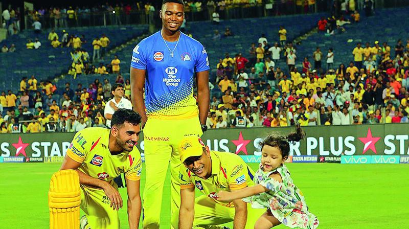 M.S. Dhoni plays with his daughter Ziva as CSK teammates Deepak Chahar (left) and Lungi Ngidi look on. (Photo: BCCI)