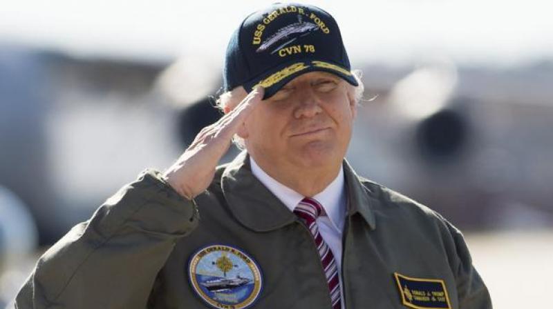 US President Donald Trump salutes as he travelled to Newport News, Virginia, to visit the pre-commissioned USS Gerald R. Ford aircraft carrier. (Photo: AFP)