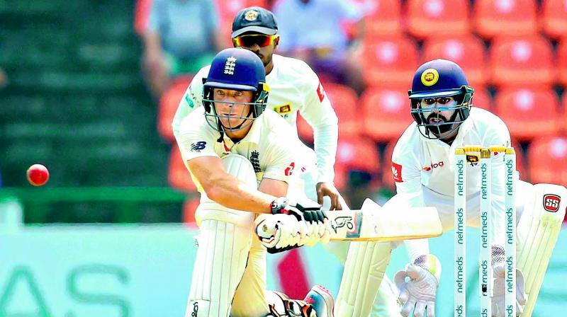 Englands Jos Buttler plays a reverse sweep against Sri Lanka during the second Test at Kandy. 	(Photo: AFP)
