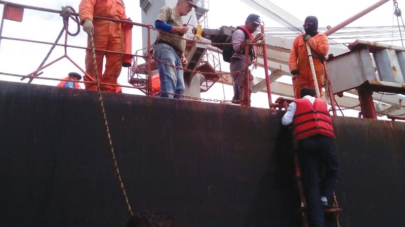 Law enforcement officials board MV Amber L to inspect the ship following the boat accident in Kochi on Monday.  (Photo: DC)