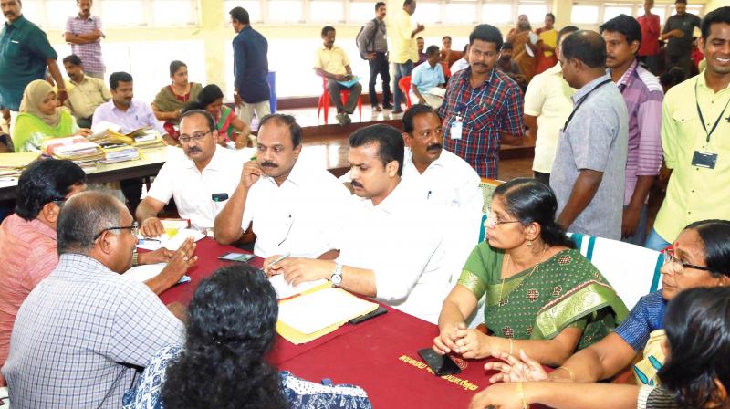 Mayor V.K. Prasanth listens to complaints as the building adalat is in progress on Monday. Corporation Secretary Deepa L.S, standing committee chairpersons Shafeera Beegum and Satheesh Kumar R, as well as Nanthancode councillor Palayam Rajan can be seen. (Photo: DC)