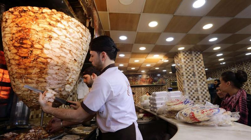 Shawarma is typically cooked outdoors, with spiced chicken (Photo: AFP)