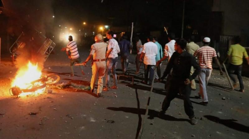 Rioters hurl stones and sticks during a communal riot that escalated due to clamping illegal water connection in a religious place in Moti Karanja area of Aurangabad. (photo: PTI)