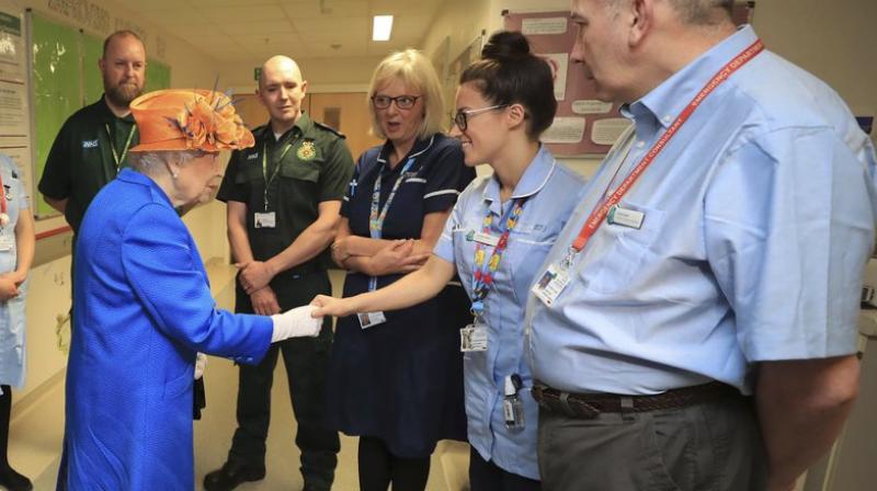 Britains Queen Elizabeth II speaks with hospital personnel as she visits the Royal Manchester Childrens Hospital to meet victims of the terror attack in the city earlier this week and to thank members of staff who treated them (Photo: AP)