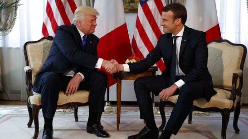 Donald Trump, Emmanuel Macron  President Donald Trump shakes hands with French President Emmanuel Macron during a meeting at the U.S. Embassy, Thursday (Photo: AP)