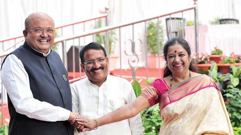 (From L) H.M. Revanna, R.B. Thimmapur and Geetha Mahadevprasad after taking oath as ministers at Raj Bhavan in Bengaluru on Friday 	 Shashidhar B.