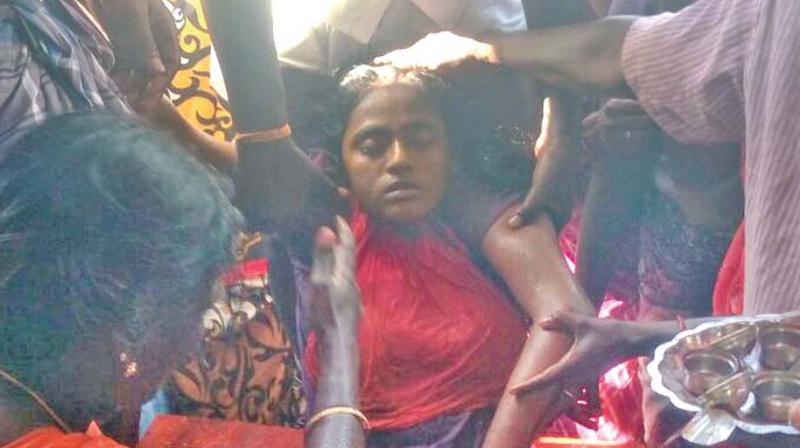 Villagers grieve over the death of Anitha. 	(Photo:DC)