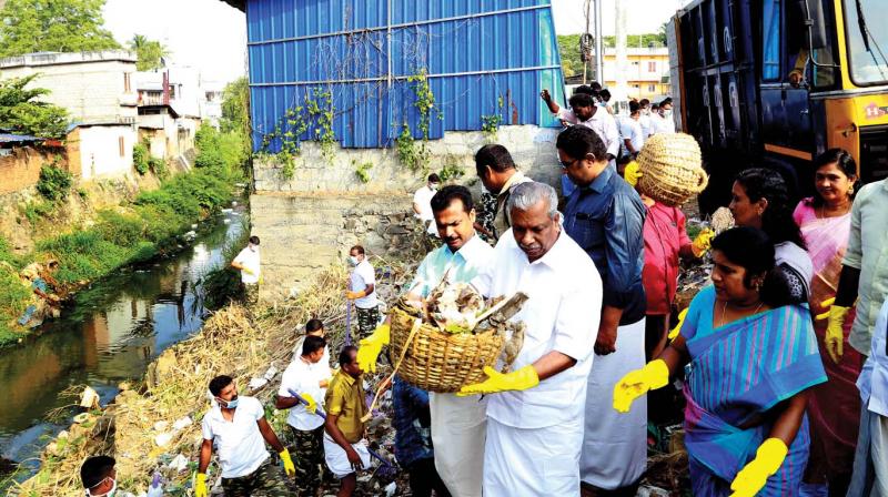 Local administration minister A.C. Moideen and mayor V.K. Prasanth join volunteers to clean Killiyar after inaugurating a cleaning drive at Killippalam in the state capital on Tuesday (Photo:  Peethambaran Payyeri)