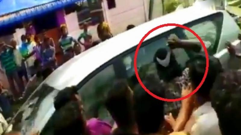 The video shows the man advancing towards Manians SUV with a sickle, forcing it to reverse. He has been identified as Raja. (Photo: Screengrab | ANI)