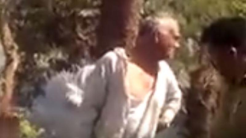 Angry residents of a municipal ward in Vadodara, on Tuesday, tied a Bharatiya Janata Party (BJP) corporator to a tree and beat him up. (Photo: Youtube Screengrab | hri joshi)