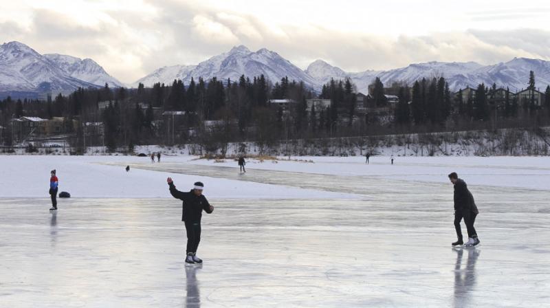 Ice skaters take advantage of unseasonable warm temperatures to ice skate outside at Westchester Lagoon in Anchorage, Alaska. (Photo: AP)