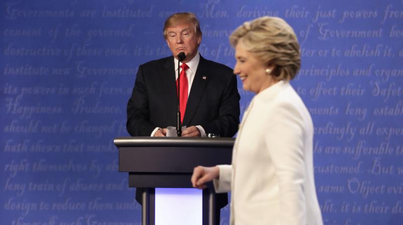 Republican presidential nominee Donald Trump waits behind his podium as Democratic presidential nominee Hillary Clinton makes her way off the stage following the third presidential debate at UNLV in Las Vegas. (Photo: AP)