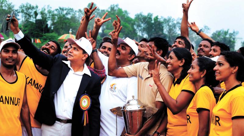 Kannur district police chief Sanjay Kumar Gurudin takes a selfie with winners Kannur Police team in Kozhikode on Saturday. (Photo: DC)