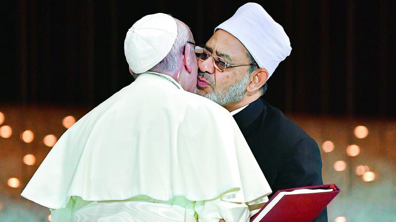 Pope Francis and Egypts Azhar Grand Imam Sheikh Ahmed al-Tayeb greet each other as they exchange documents during the Human Fraternity Meeting at the Founders Memorial in Abu Dhabi.  (Photo:AFP)