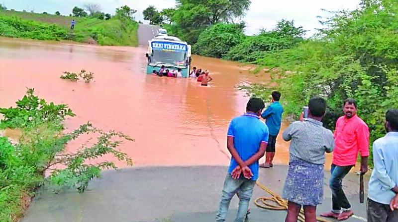 A bus carrying Kaleshwaram visitors was struck in flood water of the Chandruvalli rivulet in old Karimnagar district on Sunday.