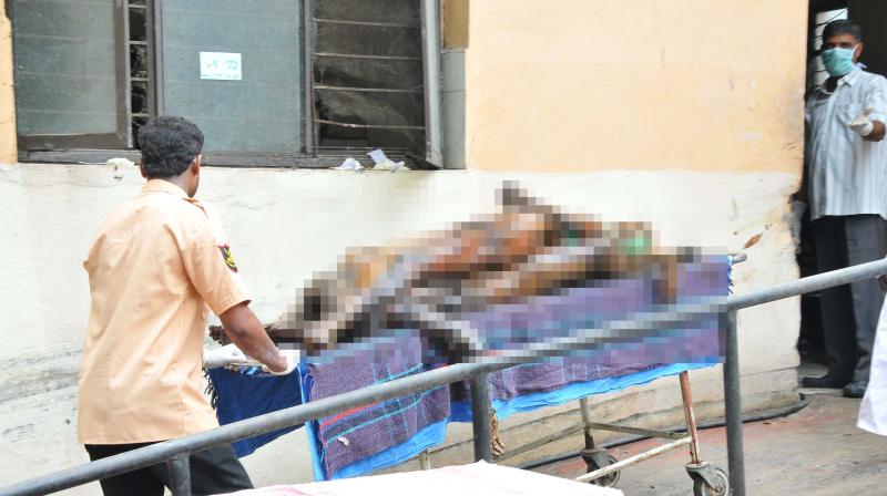 Bodies placed one on top of the other taken away by staffers, at the Osmania Hospital on Saturday. (Photo: DC)