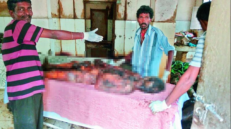 GHMC staff workers and forensic science workers clean up the highly  decomposed bodies that were dumped in the Osmania General Hospital without the luxury of having face masks to ward off the stench.