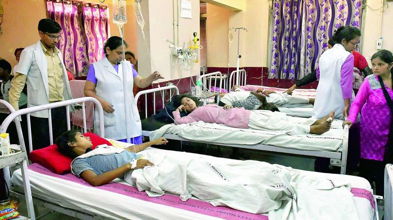 School students being treated at a hospital in New Delhi on Saturday. (Photo: PTI)
