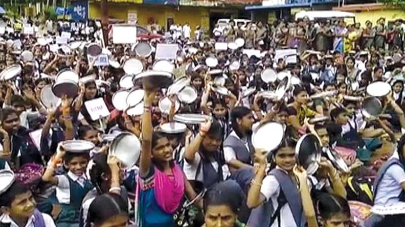 A file photo of students and staff of schools run by RSS strongman Kalladka Prabhakar Bhat protesting when the previous Congress government stopped the benefits of the meal scheme to the schools.