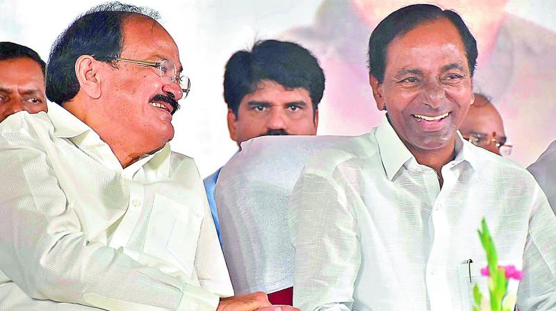 Vice-President M. Venkaiah Naidu and Chief Minister K. Chandrasekhar Rao in a lighter mood during a felicitation function at Raj Bhavan in Hyderabad on Monday.